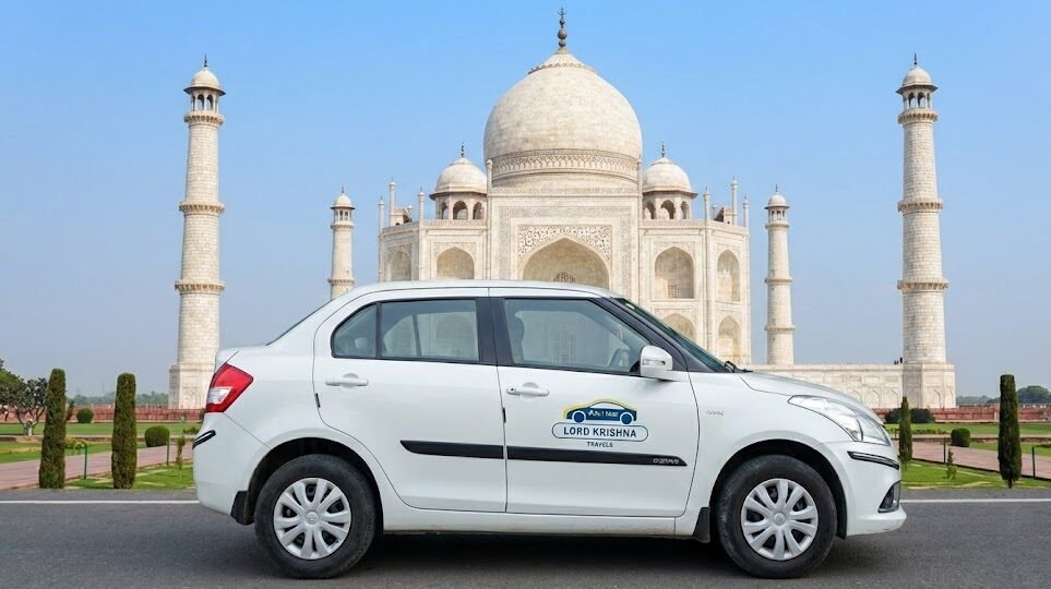 a lord krishna travels sedan parked in front of the taj mahal in agra, representing corporate weekend getaway trips.