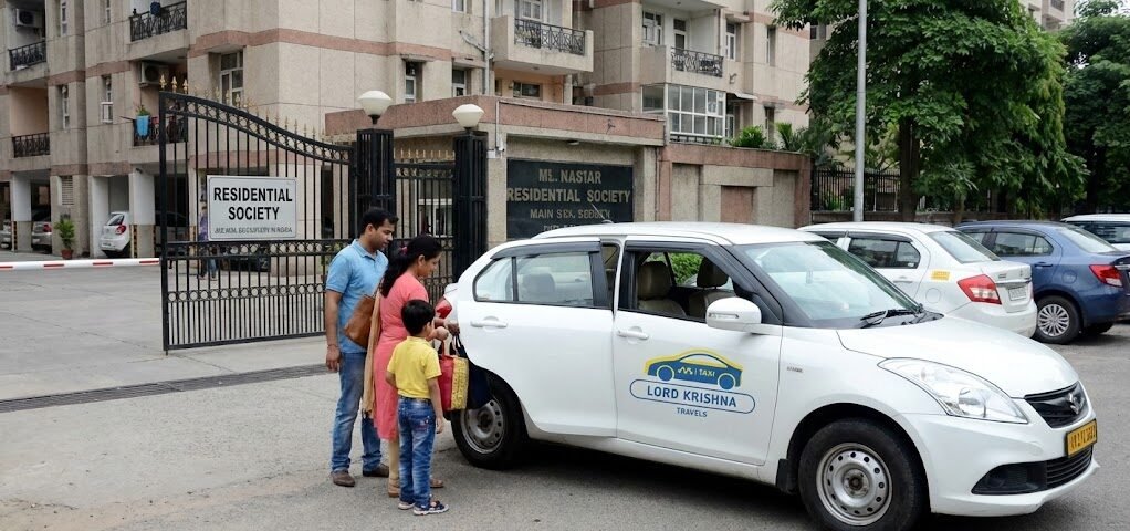 a family getting into a lord krishna travels taxi outside a residential society gate in noida, showing safe cab service for families and visiting relatives.